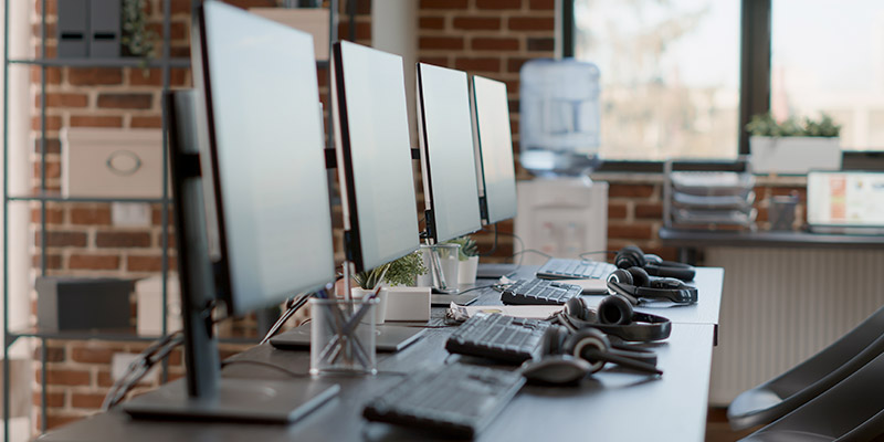 Des ordinateurs de bureau alignés les uns à côté des autres.